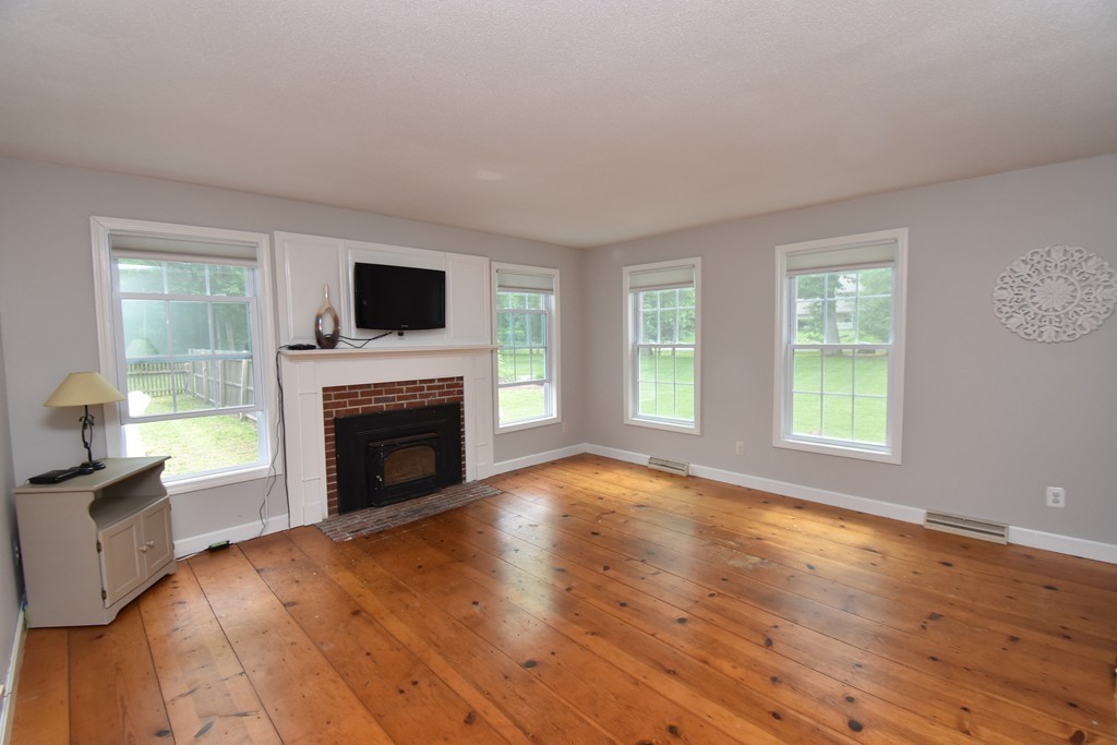 286 Main Road Montgomery, MA 01085 - Photo 12 of 27 a view of empty room with fireplace and wooden floor