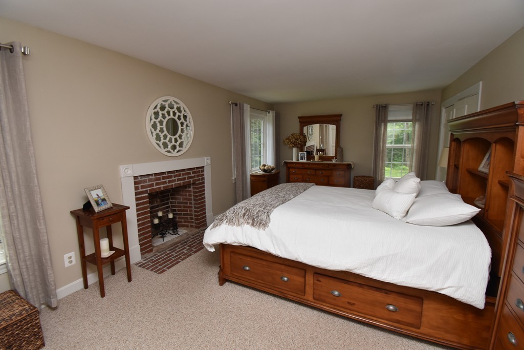 286 Main Road Montgomery, MA 01085 - Photo 14 of 27 a spacious bedroom with a bed and a fireplace