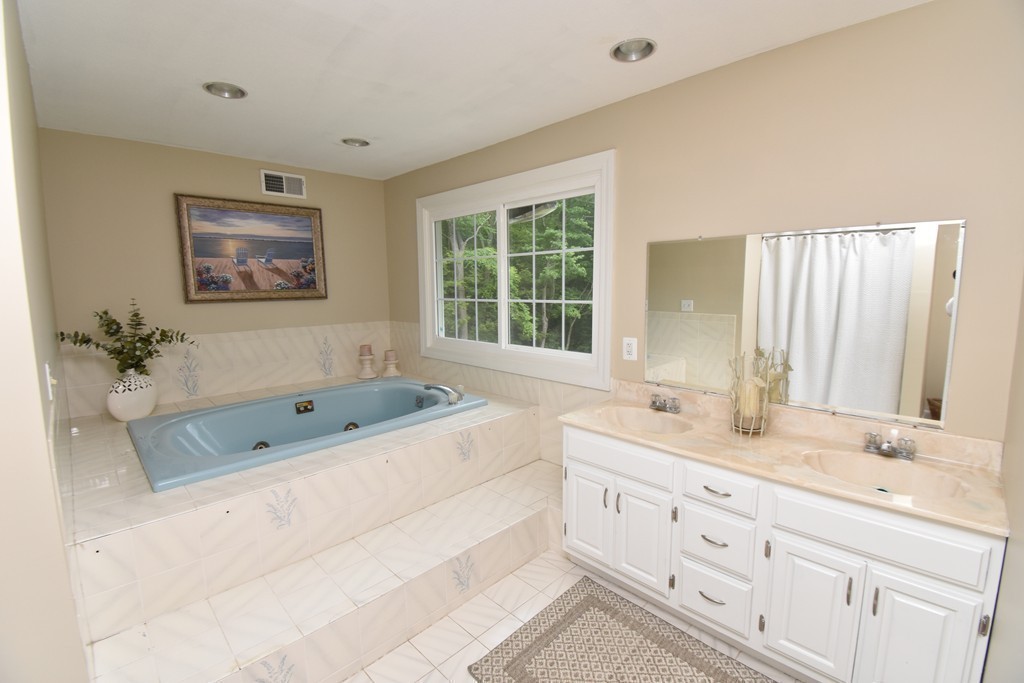 286 Main Road Montgomery, MA 01085 - Photo 15 of 27 a bathroom with a granite countertop double vanity sink large mirror bathtub and double