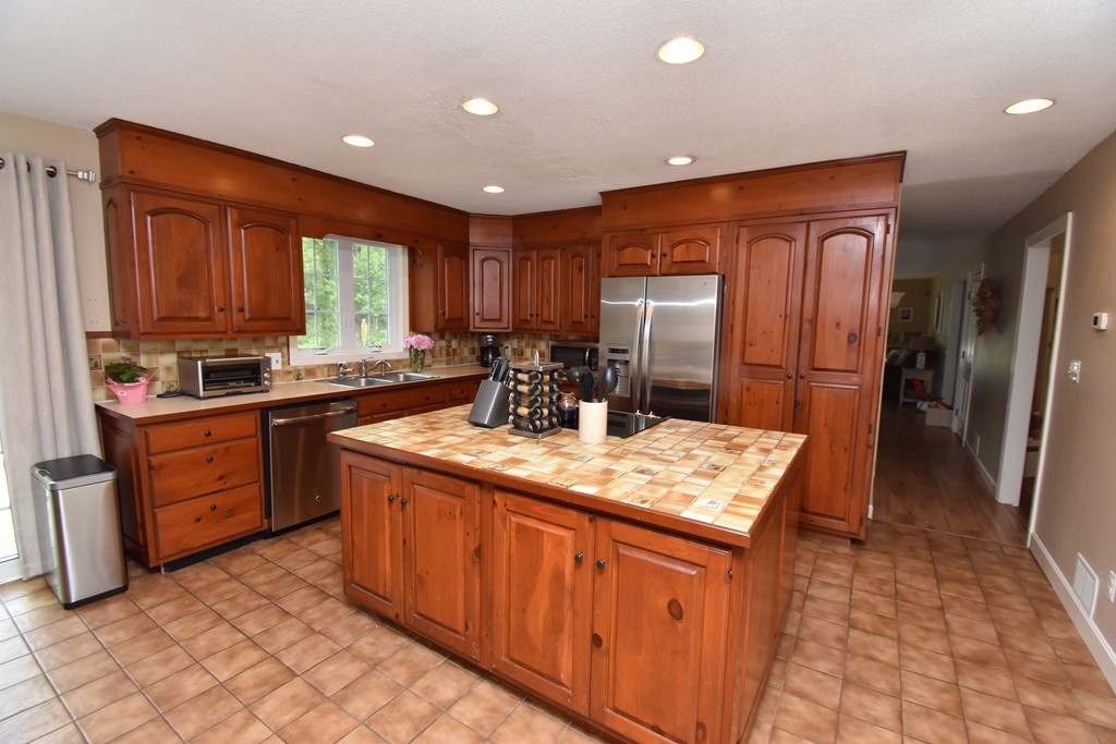 286 Main Road Montgomery, MA 01085 - Photo 3 of 27 a kitchen with stainless steel appliances granite countertop a sink stove and refrigerator