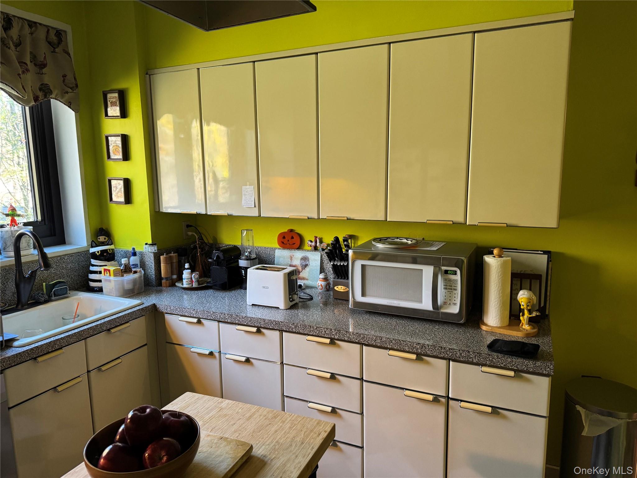 1101 Midland Avenue, Unit 402 Bronxville, NY 10708 - Photo 10 of 20 a kitchen with sink cabinets and window