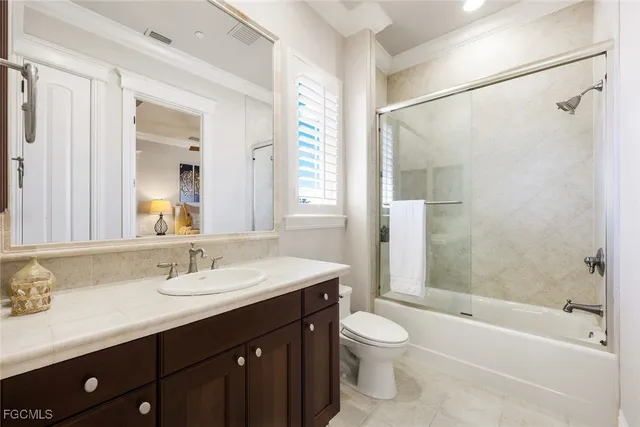 a bathroom with a double vanity sink mirror and shower