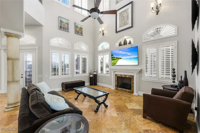 a living room with furniture a fireplace and a large window