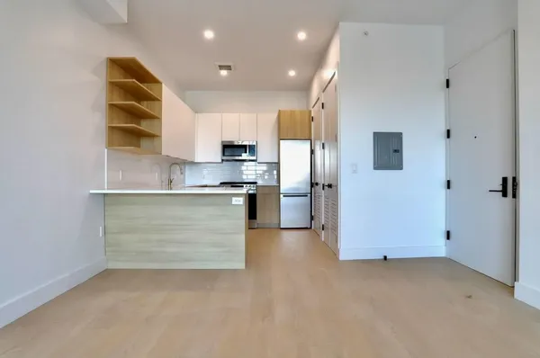 a kitchen with cabinets and stainless steel appliances