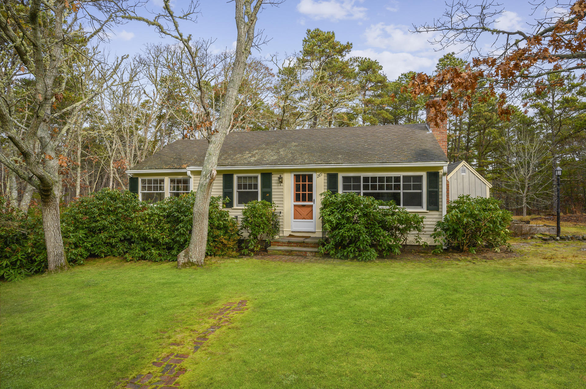 289 Cahoon Hollow Road Wellfleet, MA 02667 - Photo 1 of 25 a front view of a house with a yard and tree