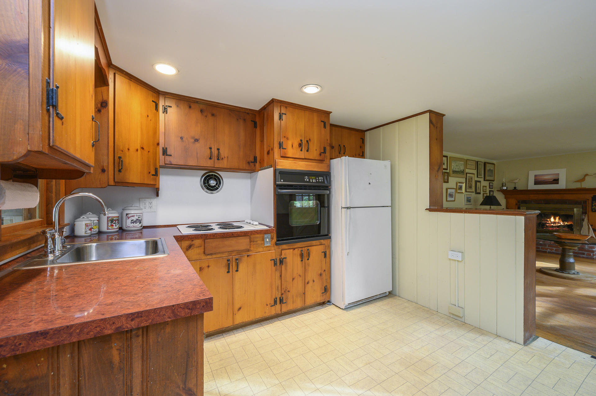 289 Cahoon Hollow Road Wellfleet, MA 02667 - Photo 9 of 25 a kitchen with stainless steel appliances granite countertop a refrigerator a stove a sink and a microwave