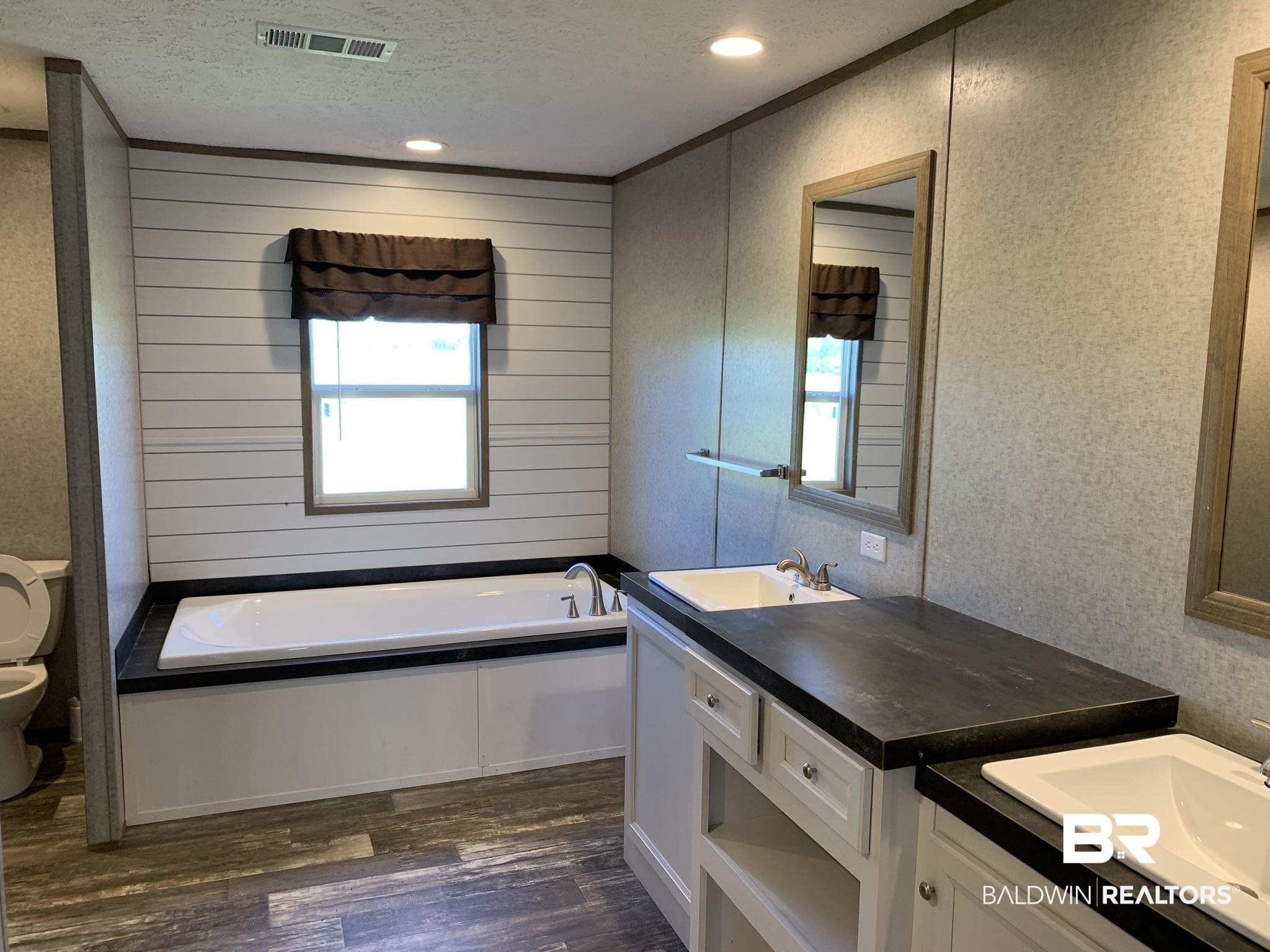 16876 County Road 87 Elberta, AL 36530 - Photo 3 of 13 Bathroom featuring vanity, a bathtub, wood-type flooring, a textured ceiling, and toilet