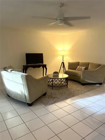 a living room with furniture and a lamp