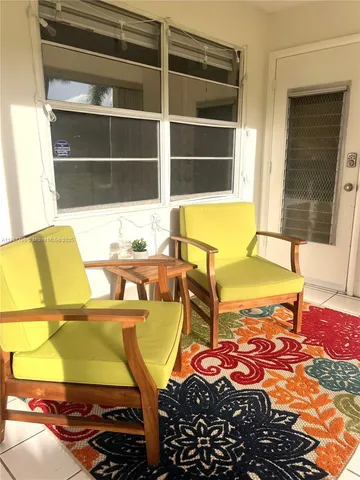 a view of a swimming pool with a dining table and chairs