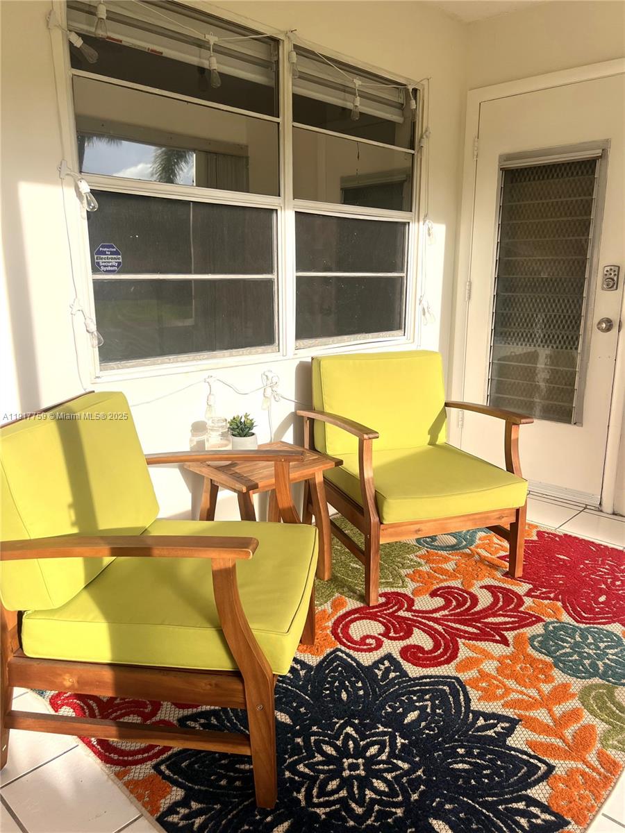5300 Washington Street, Unit R102 Hollywood, FL 33021 - Photo 4 of 11 a view of a swimming pool with a dining table and chairs