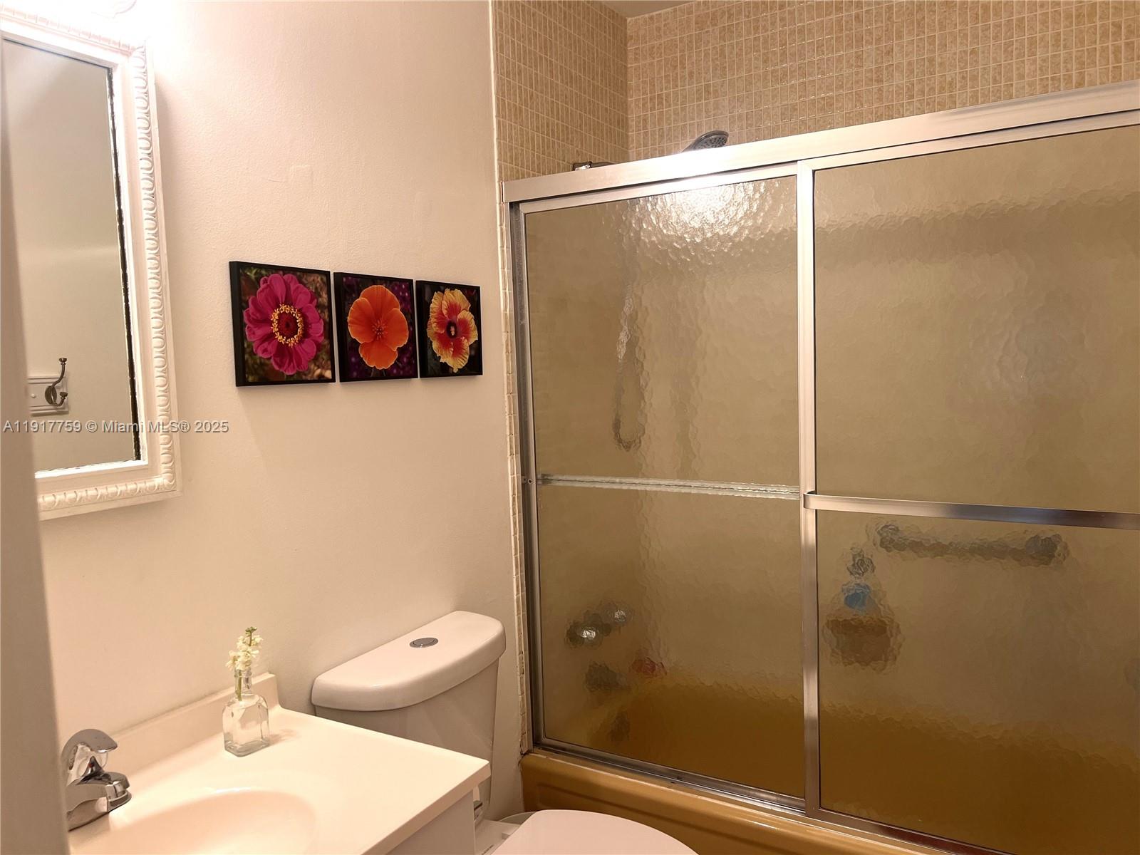 5300 Washington Street, Unit R102 Hollywood, FL 33021 - Photo 8 of 11 a bathroom with a shower and toilet