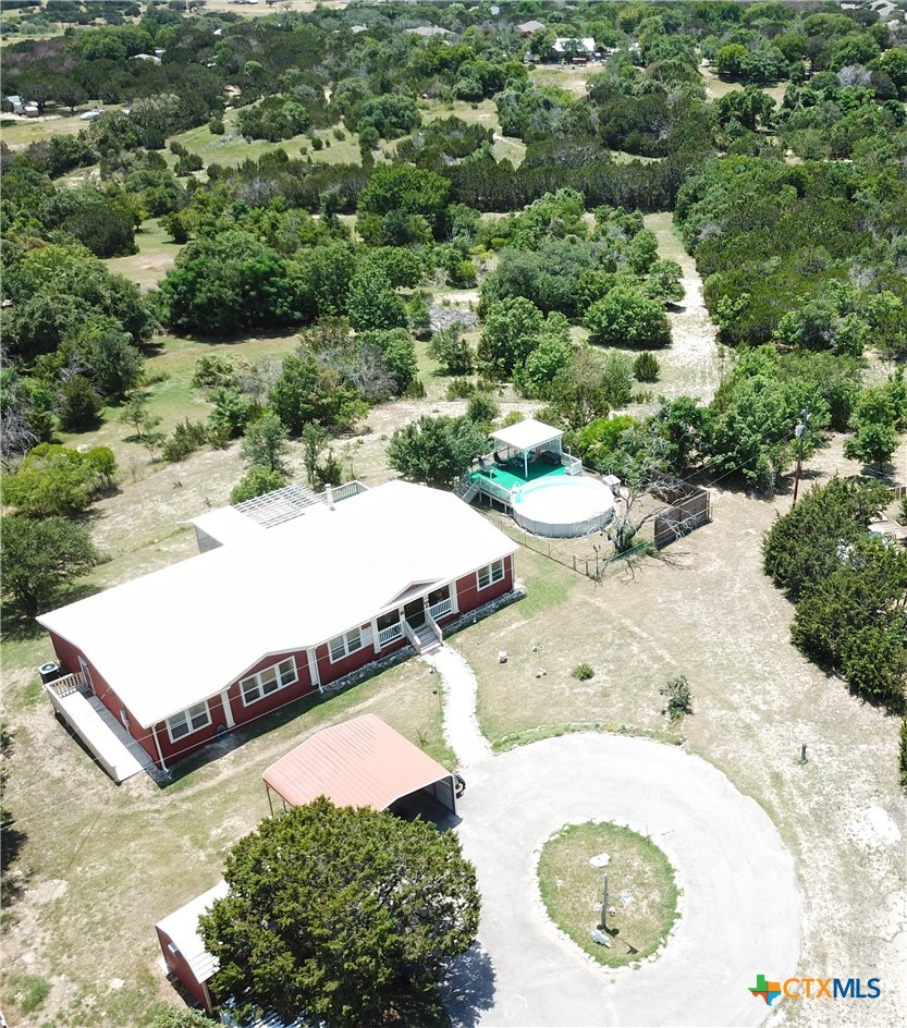 an aerial view of a house with yard
