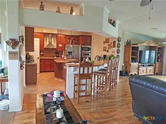 a kitchen with stainless steel appliances granite countertop a sink stove and a refrigerator