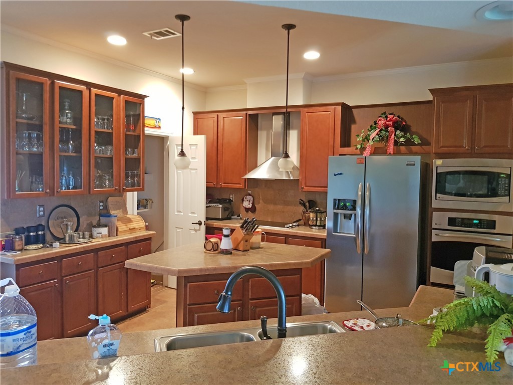 935 County Road 4820 Kempner, TX 76539 - Photo 24 of 48 a kitchen with stainless steel appliances granite countertop a refrigerator a sink dishwasher and a stove