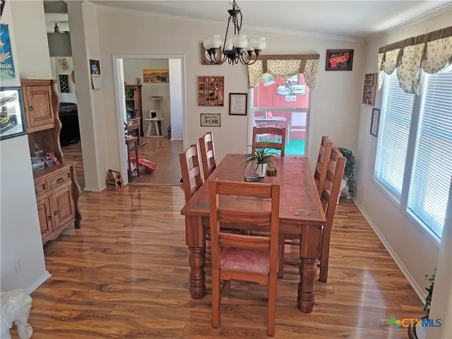 a dining room with furniture and wooden floor