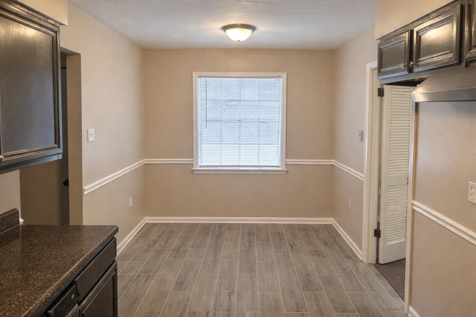 3300 Keystone Avenue Memphis, TN 38128 - Photo 7 of 18 Unfurnished dining area with wood tiled floors and baseboards
