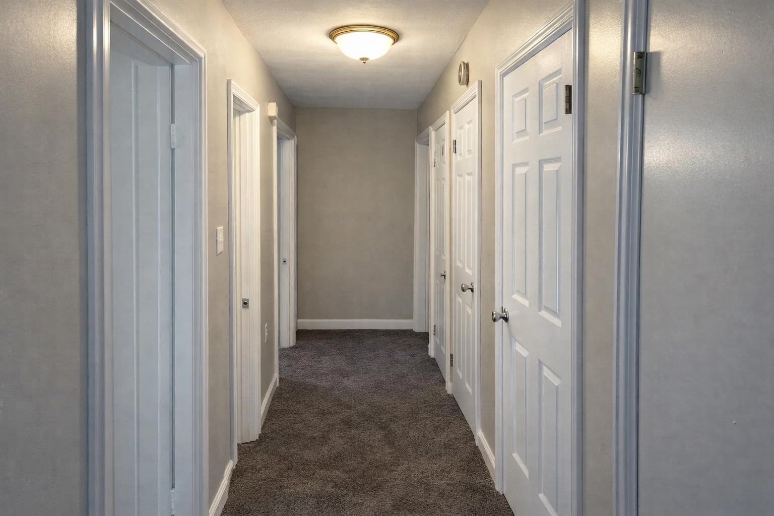 3300 Keystone Avenue Memphis, TN 38128 - Photo 9 of 18 Hallway featuring dark carpet and baseboards
