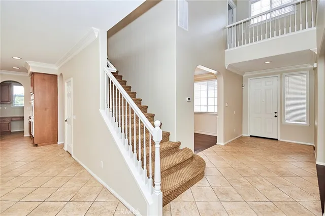 a view of a hallway with entryway and stairs