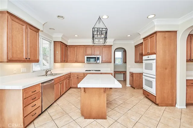 a large kitchen with stainless steel appliances granite countertop a stove a sink dishwasher and cabinets