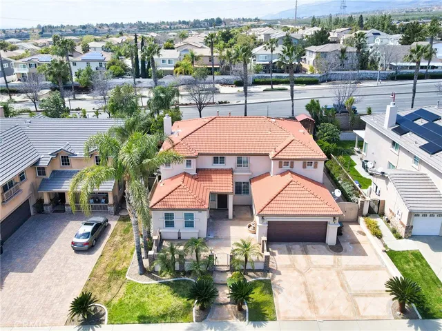 an aerial view of multiple houses with yard