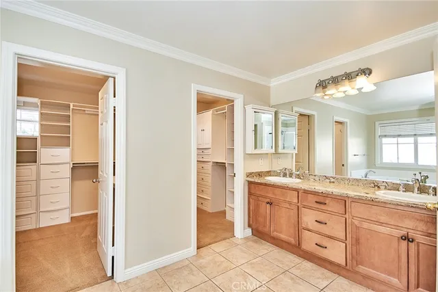 a spacious bathroom with a granite countertop sink a mirror and a