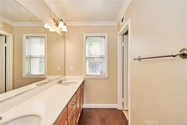 a bathroom with a granite countertop sink a mirror and a shower