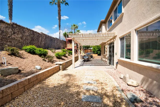 a view of a patio with table and chairs and wooden fence