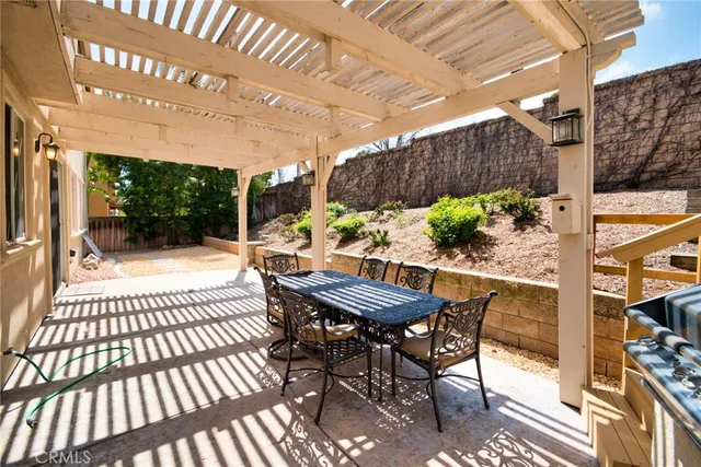 a view of a patio with a table and chairs
