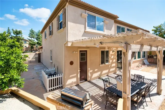 a view of a house with backyard and sitting area