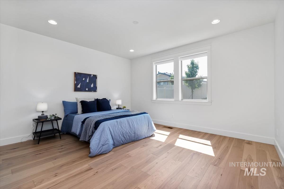 11379 West Helenium Drive Star, ID 83669 - Photo 21 of 50 Bedroom with light wood-style flooring and recessed lighting