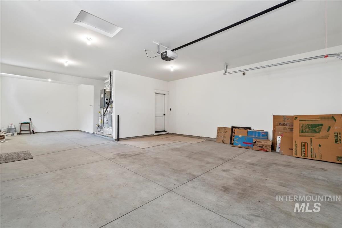 11379 West Helenium Drive Star, ID 83669 - Photo 38 of 50 Garage featuring a garage door opener