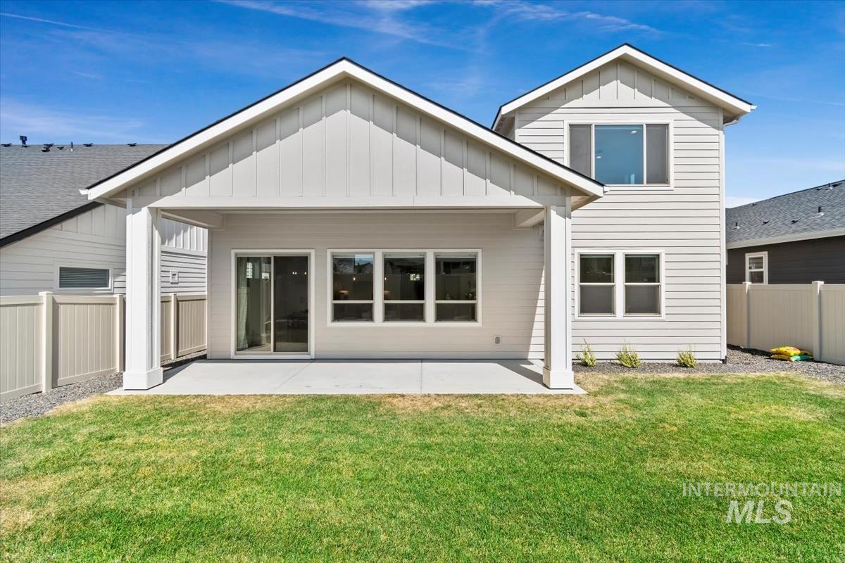 11379 West Helenium Drive Star, ID 83669 - Photo 44 of 50 Back of property featuring board and batten siding, a patio area, and a fenced backyard