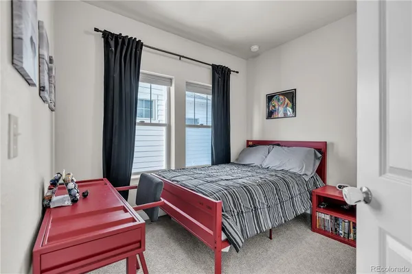 a bedroom with a bed and a chair