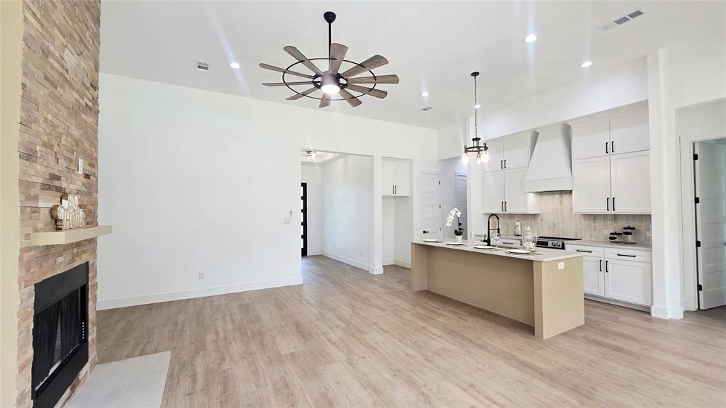 1106 East Sixth Street Springtown, TX 76082 - Photo 13 of 29 a kitchen with stainless steel appliances a stove top oven a sink and a refrigerator
