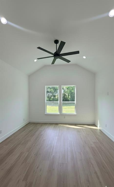1106 East Sixth Street Springtown, TX 76082 - Photo 17 of 29 a view of an empty room with a window and wooden floor