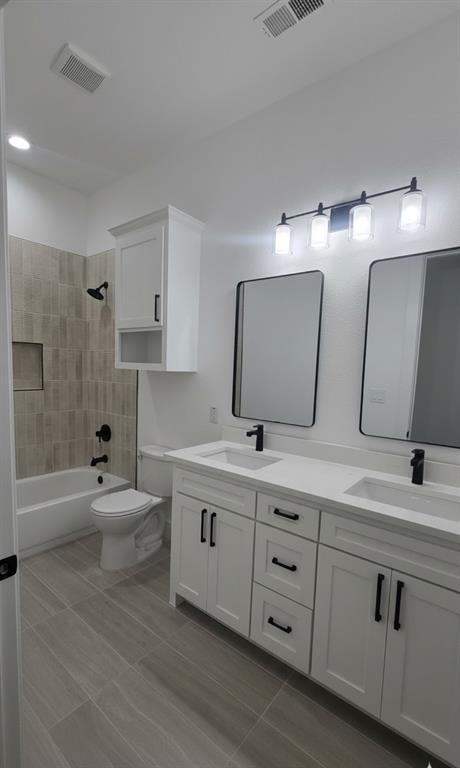 1106 East Sixth Street Springtown, TX 76082 - Photo 18 of 29 a spacious bathroom with double sink a large mirror and bathtub