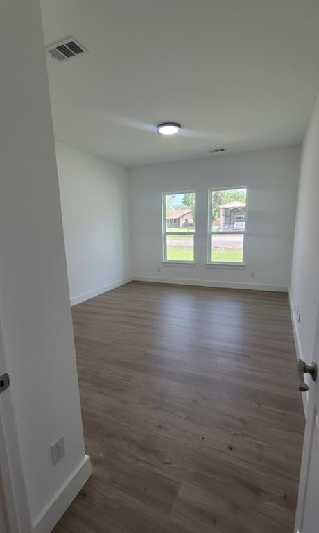 1106 East Sixth Street Springtown, TX 76082 - Photo 23 of 29 a view of room with window and hardwood floor