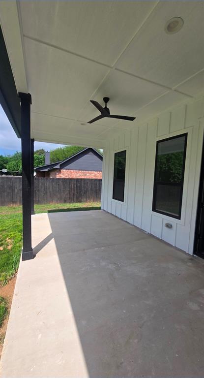 1106 East Sixth Street Springtown, TX 76082 - Photo 27 of 29 a view of an empty room with a fireplace and a floor to ceiling window
