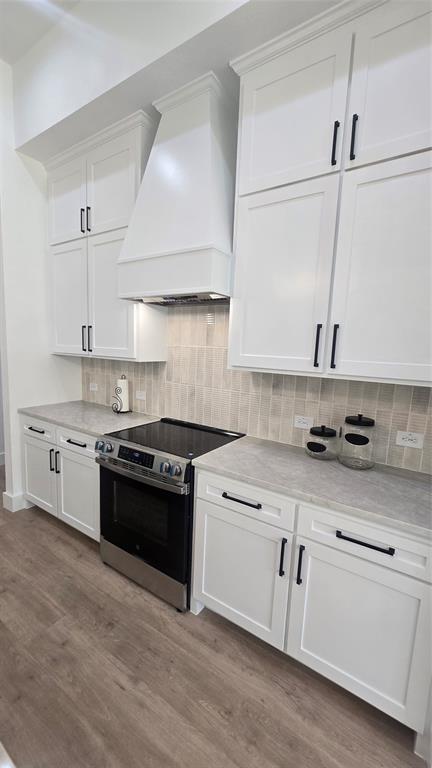 1106 East Sixth Street Springtown, TX 76082 - Photo 6 of 29 a kitchen with granite countertop white cabinets and appliances