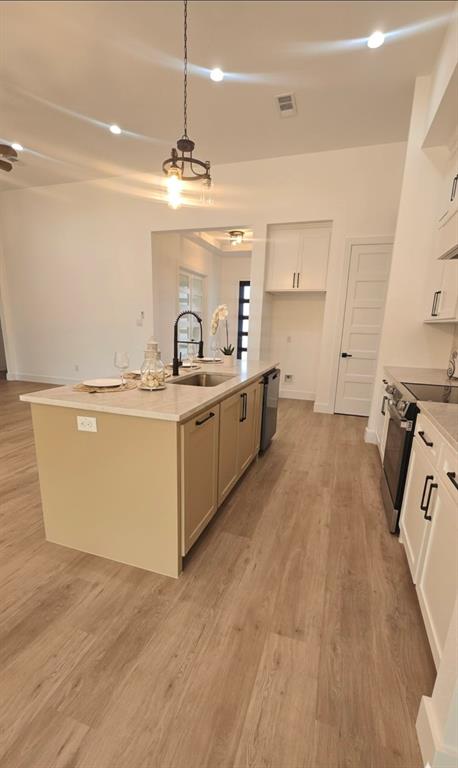 1106 East Sixth Street Springtown, TX 76082 - Photo 7 of 29 a large kitchen with a stove a sink dishwasher and a refrigerator with wooden floor