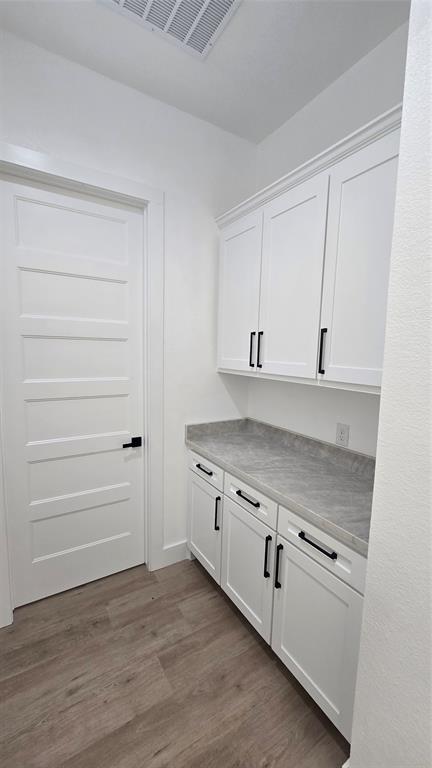 1106 East Sixth Street Springtown, TX 76082 - Photo 10 of 29 a view of a kitchen with dishwasher and wooden floor