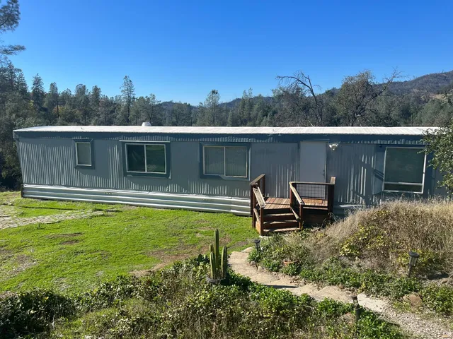 a aerial view of a house with a yard table and chairs