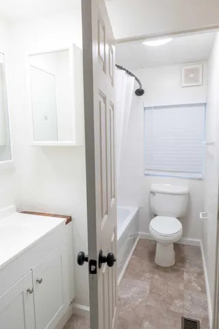 a bathroom with a toilet sink and a mirror
