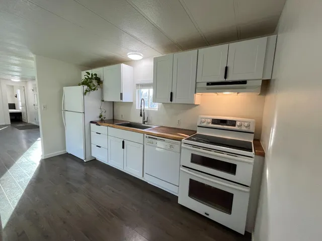a kitchen with a stove and a refrigerator
