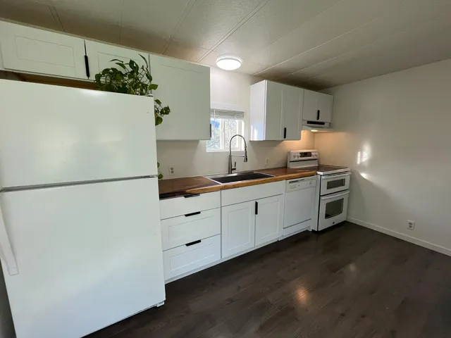 a kitchen with stainless steel appliances a refrigerator sink and cabinets
