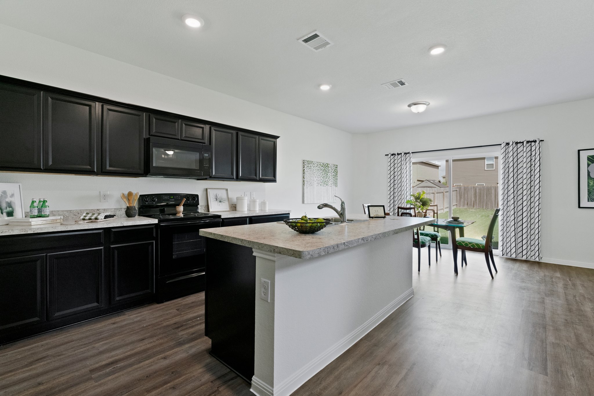 550 Bunton Reserve Boulevard Kyle, TX 78640 - Photo 14 of 32 The island kitchen offers both style and functionality for everyday living.