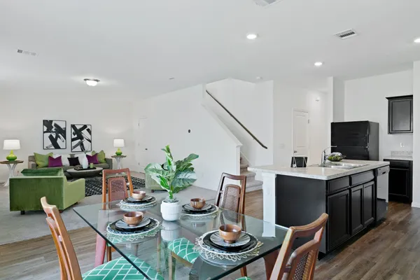 a kitchen with a sink and wooden floor