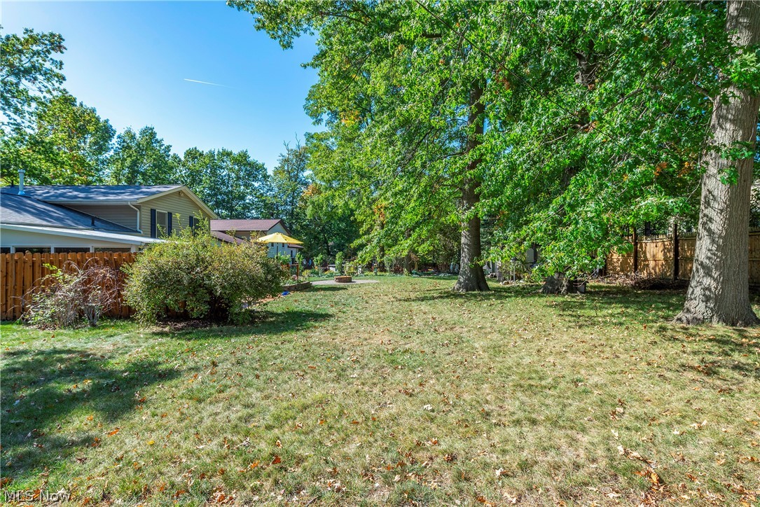 75 Houghton Road Northfield, OH 44067 - Photo 45 of 48 Expansive backyard with a manicured lawn, mature trees, and a privacy fence
