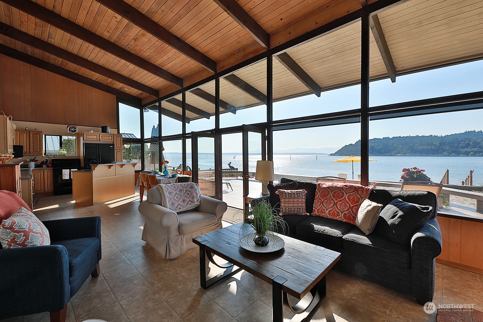 8166 Sandy Hook Drive Clinton, WA 98236 - Photo 12 of 40 a living room with furniture and floor to ceiling windows