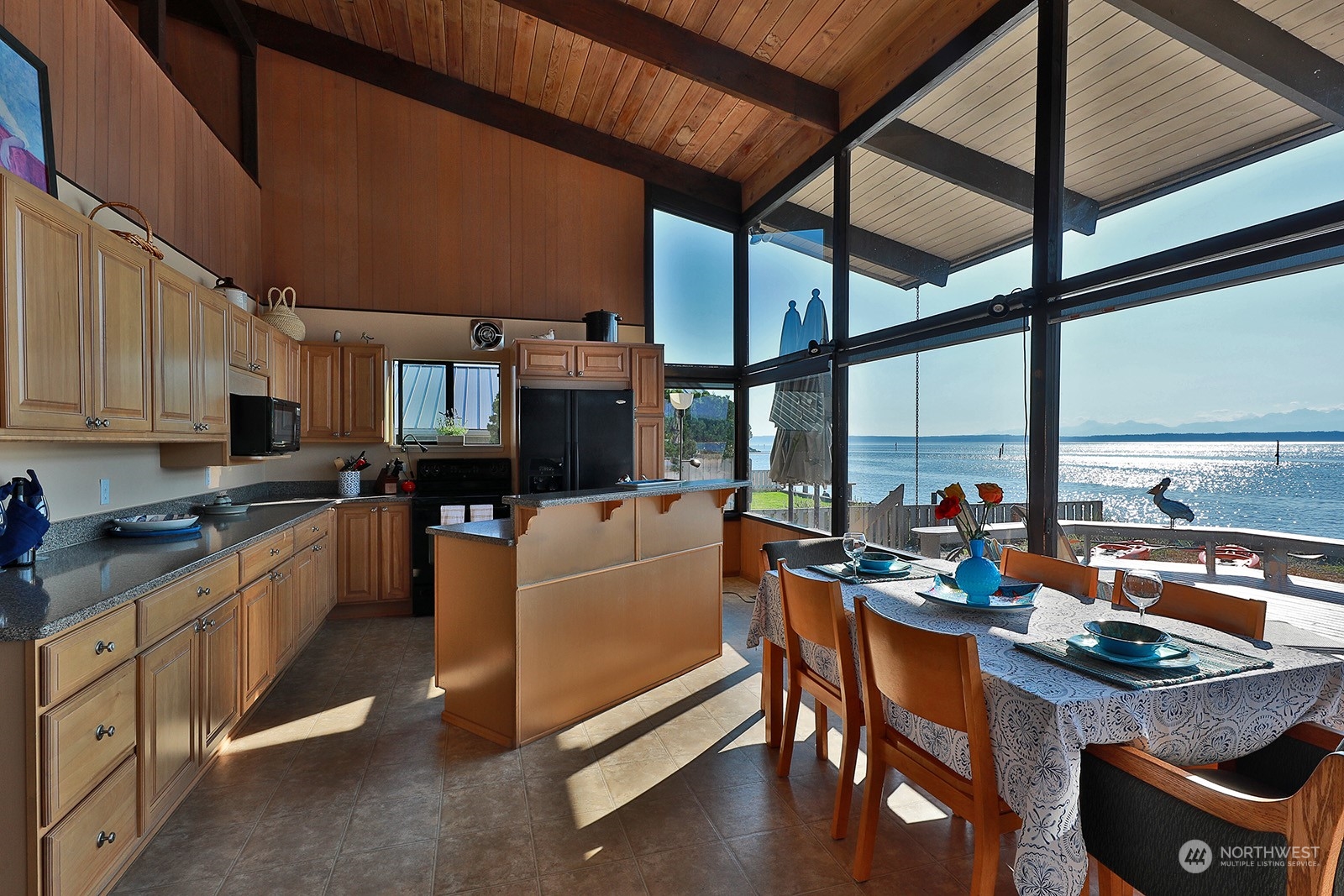 8166 Sandy Hook Drive Clinton, WA 98236 - Photo 15 of 40 a kitchen with stainless steel appliances granite countertop sink stove and cabinets